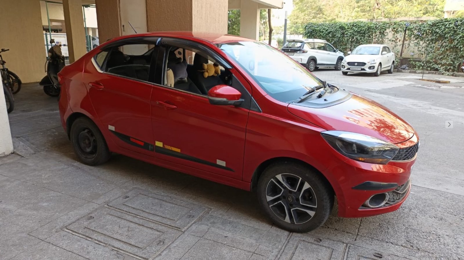 Picture of a well-traveled Tata Tigor parked on the highway