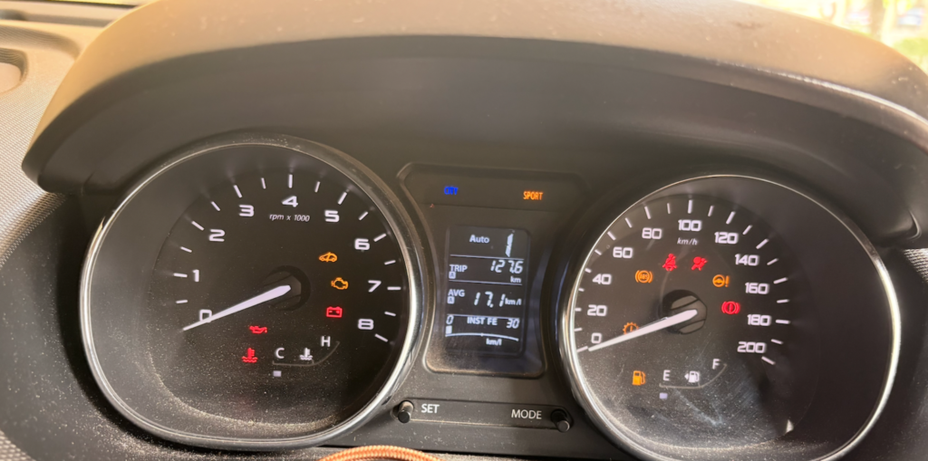 Tata Tigor MID display during Mumbai to Hyderabad road trip showing trip distance and average fuel efficiency
